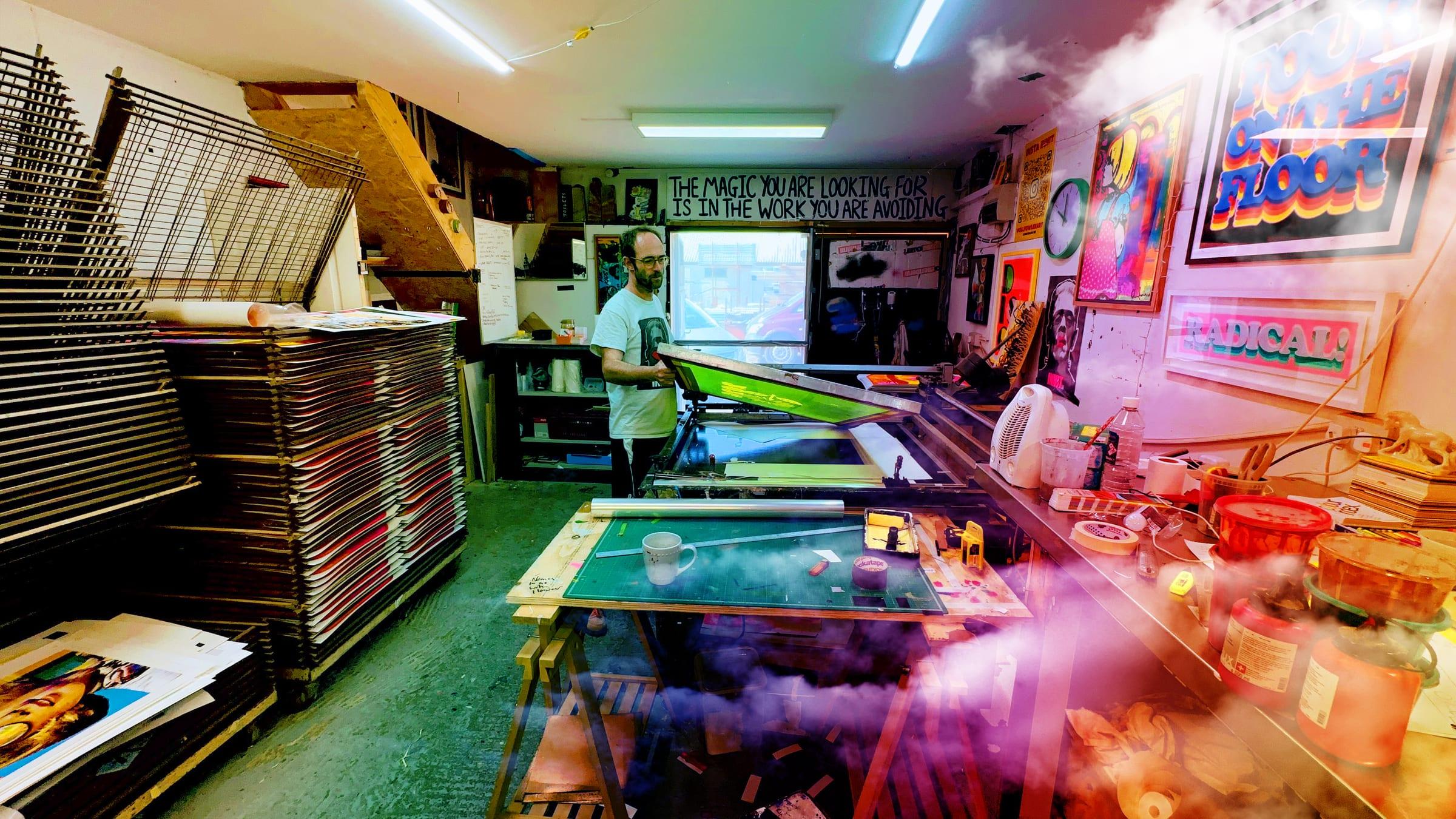 Oli Fowler pulling a screen print in the studio