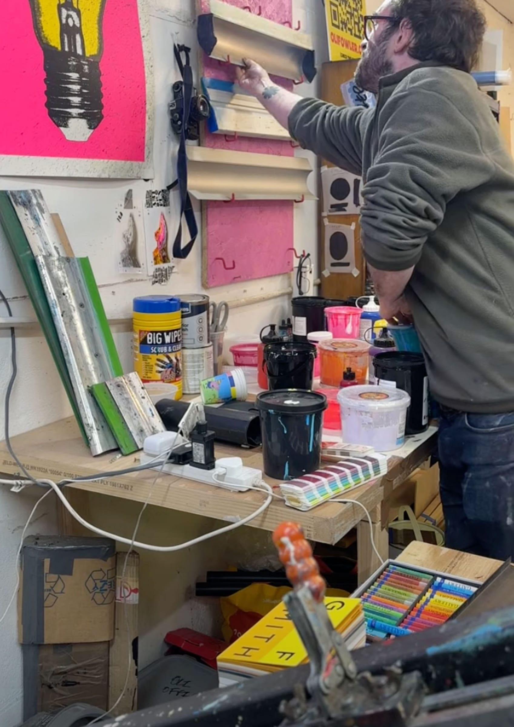 Reaching for a squeegee on the wall rack