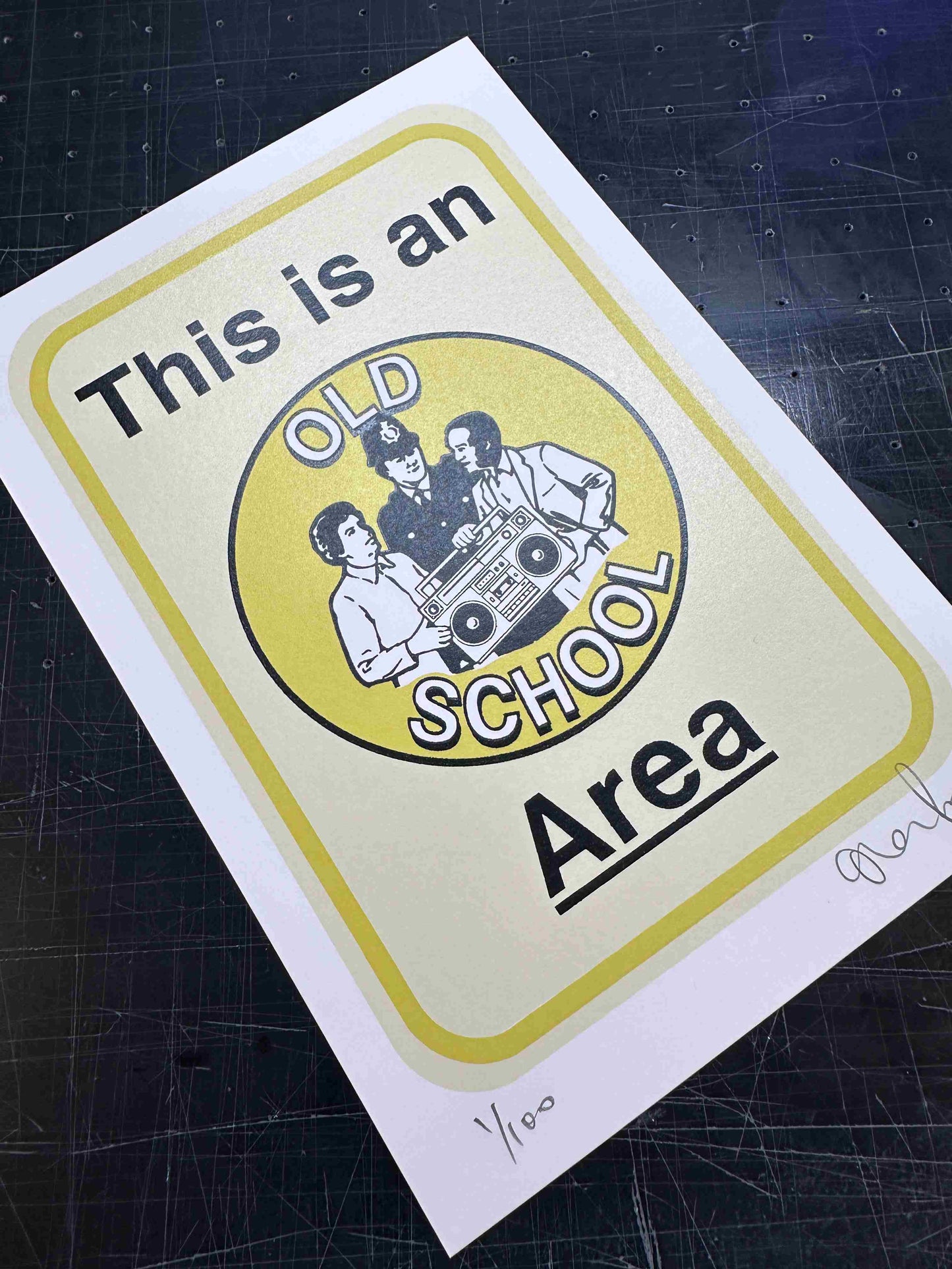 Sticker with graphic design and text on a dark surface