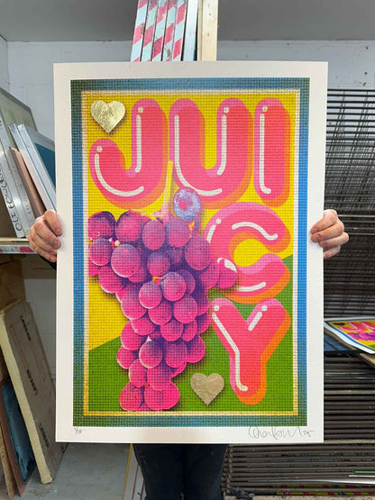 Colorful poster with 'JUICY' text and grape design held by a person.