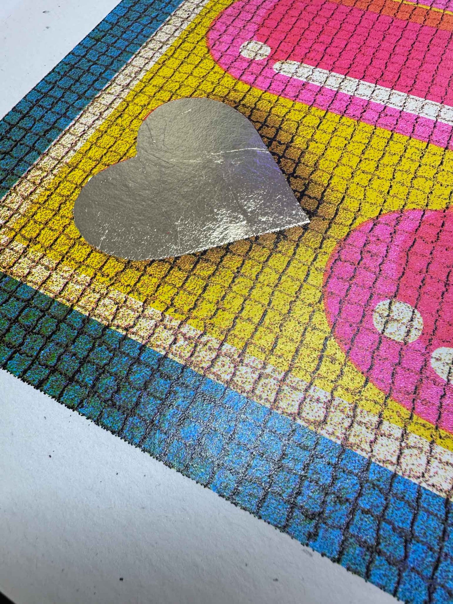 Colorful heart-shaped doormat with a metallic heart on top