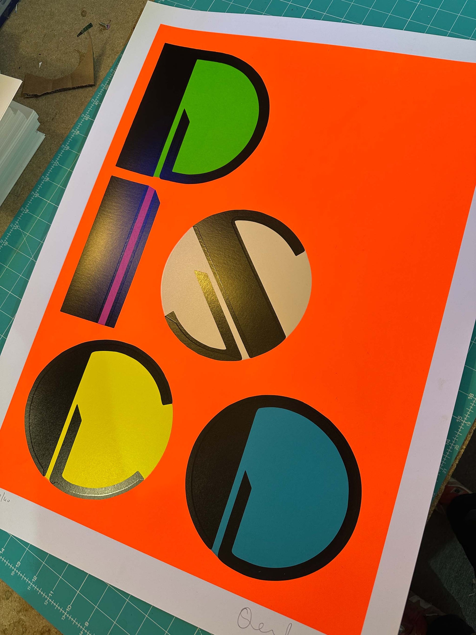 DISCO25 hand-pulled screenprint by Oli Fowler. Bold geometric lettering in neon colours on fluorescent orange.