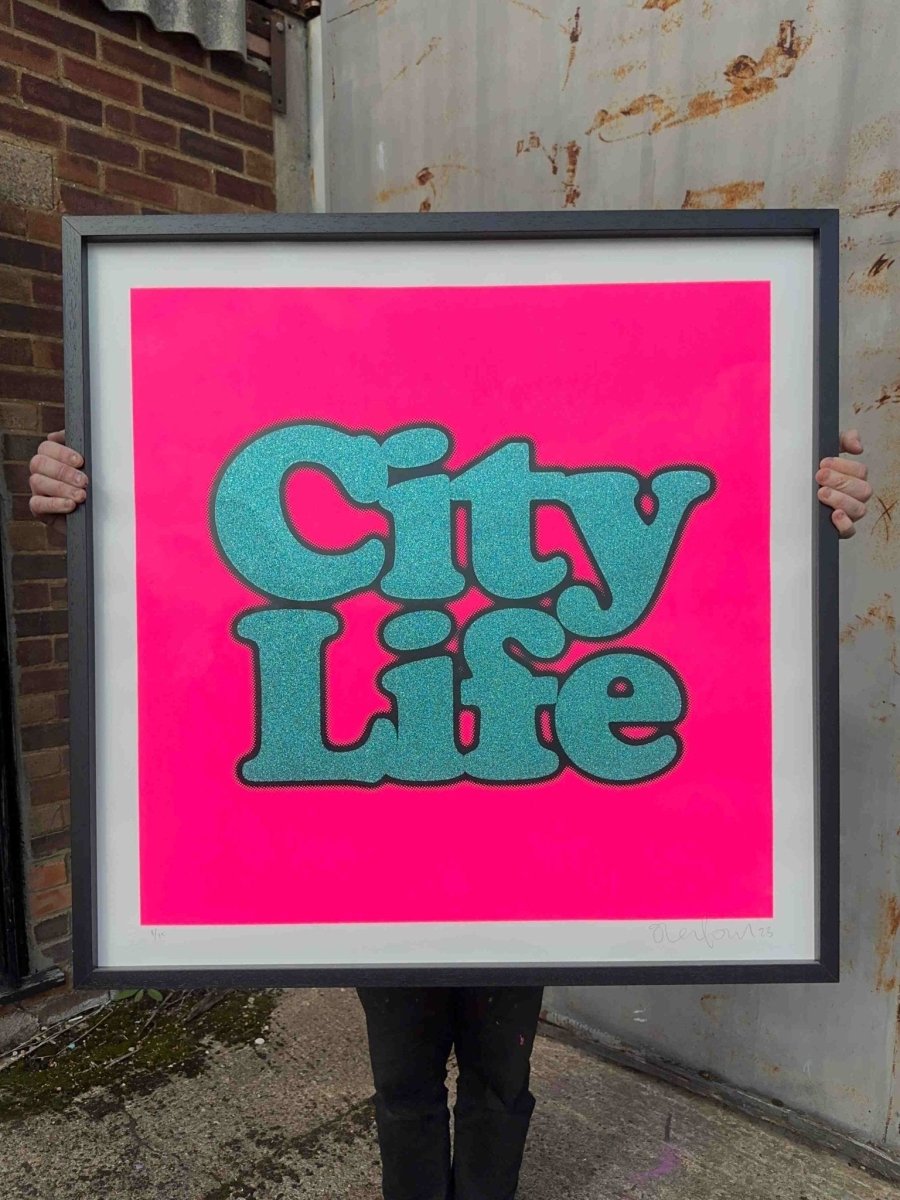 City Life XL hand-pulled screenprint by Oli Fowler. Bold teal glitter lettering on hot neon pink background.